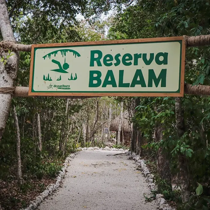 Reserva Balam entrance: Sign marking the entrance to Reserva Balam in a lush, green area