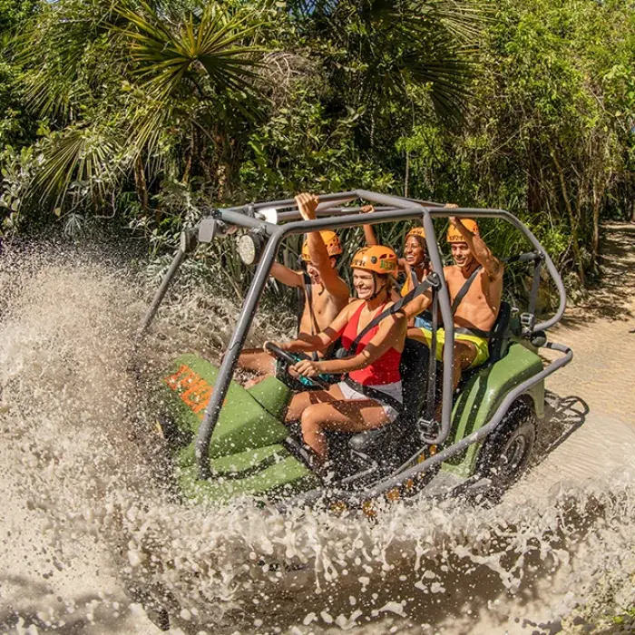 ATV splashing through water during jungle tour