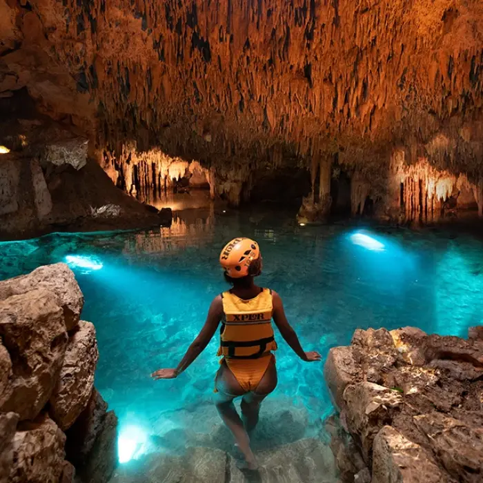 Woman enjoying the view inside a large underground cave