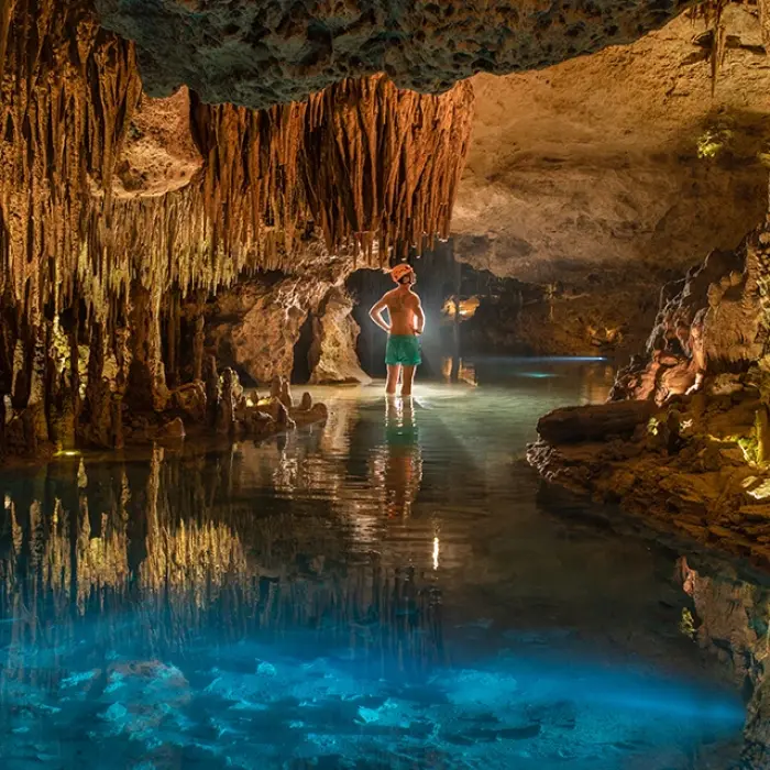 Deep cave with reflection pools and glowing rock formations