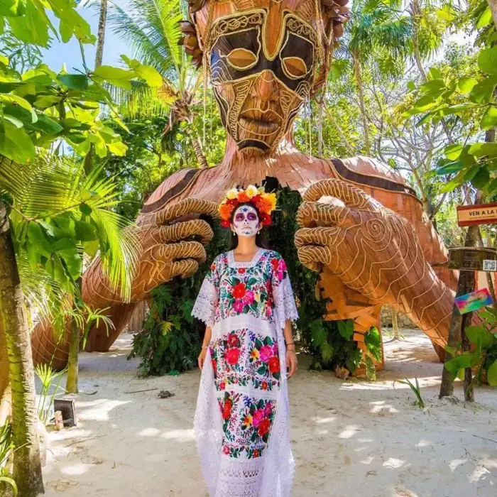 lady in festive attire stading outside Ahau Tulum