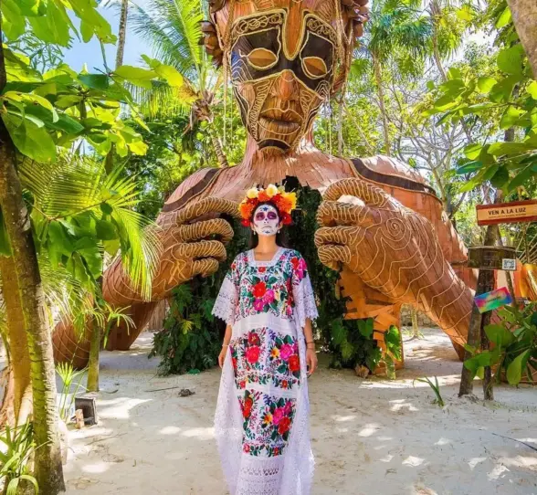 lady in festive attire stading outside Ahau Tulum