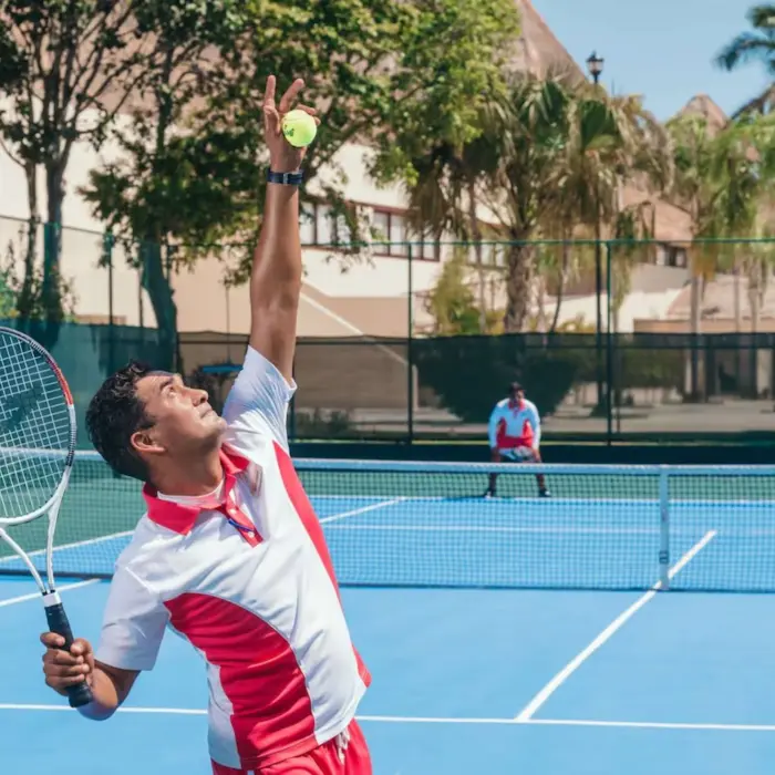 two men playing tennis at Allegro Playacar