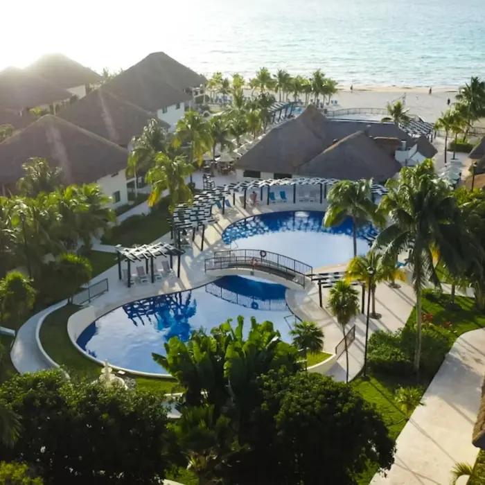 aerial view of the pools, accommodations, and beach at Allegro Playacar