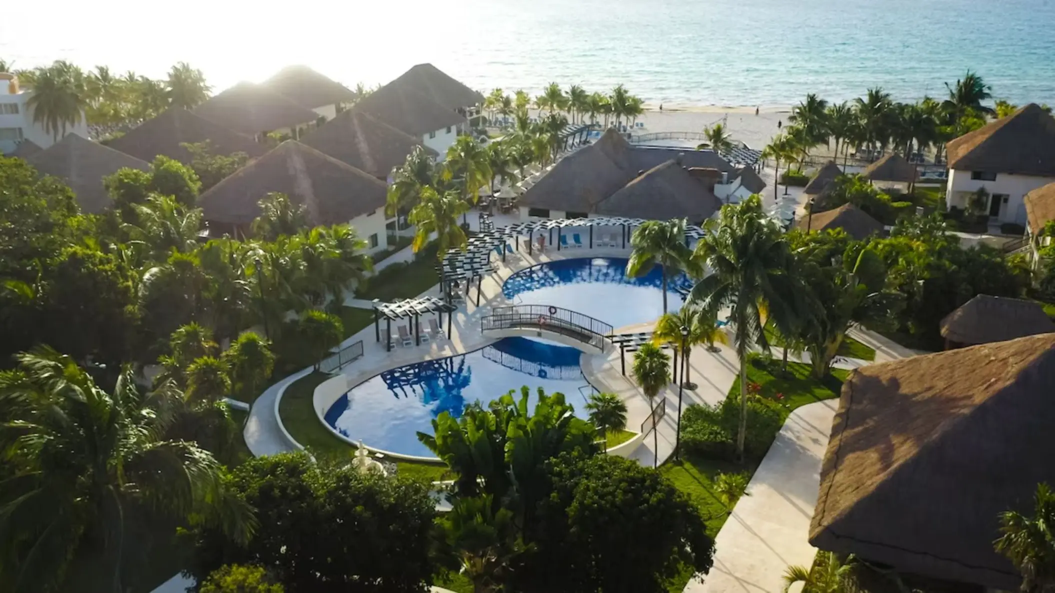 aerial view of the pools, accommodations, and beach at Allegro Playacar
