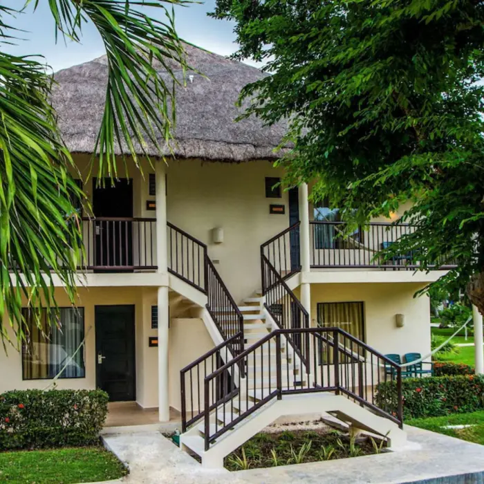 exterior of suite at Allegro Playacar with lush landscaping
