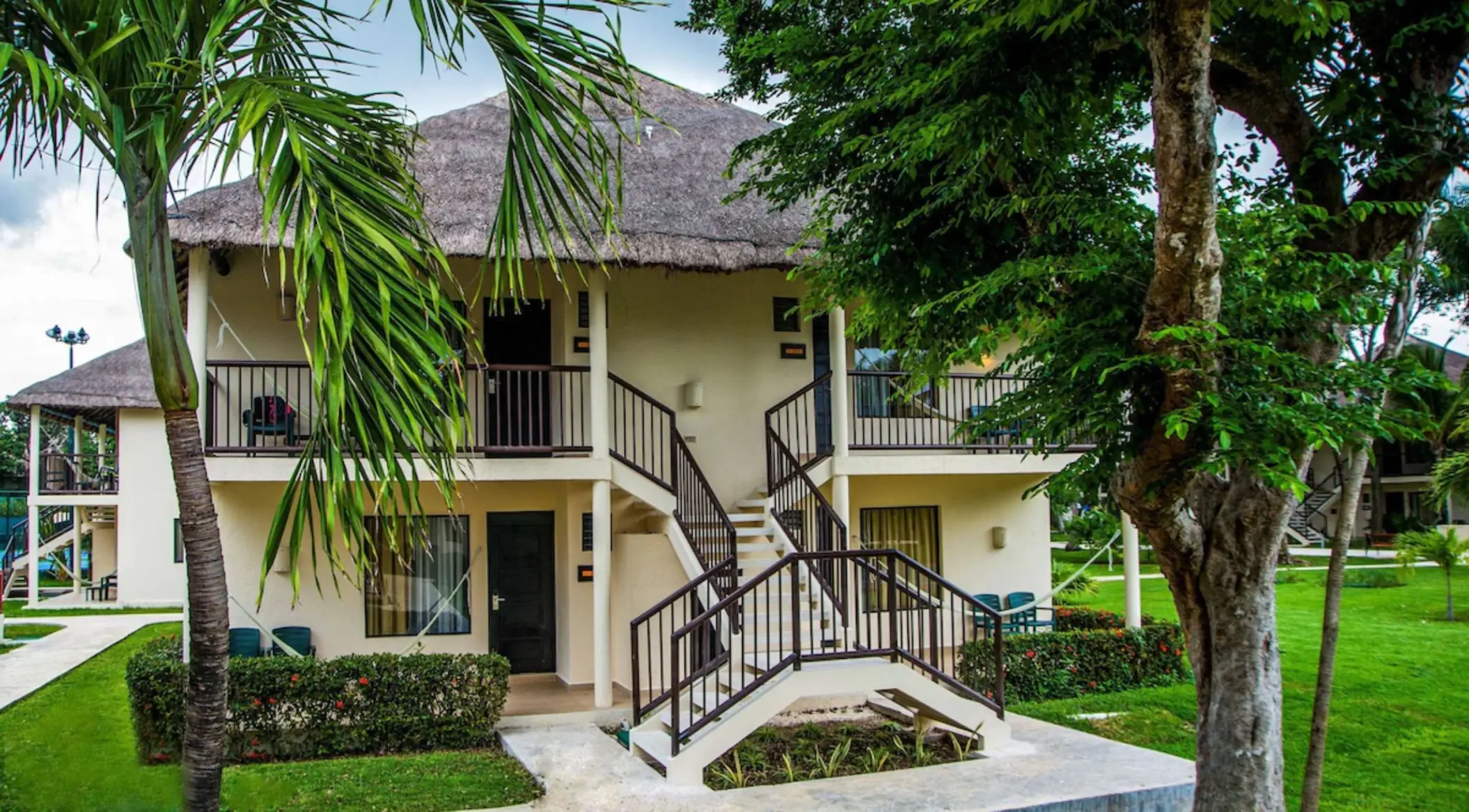 exterior of suite at Allegro Playacar with lush landscaping