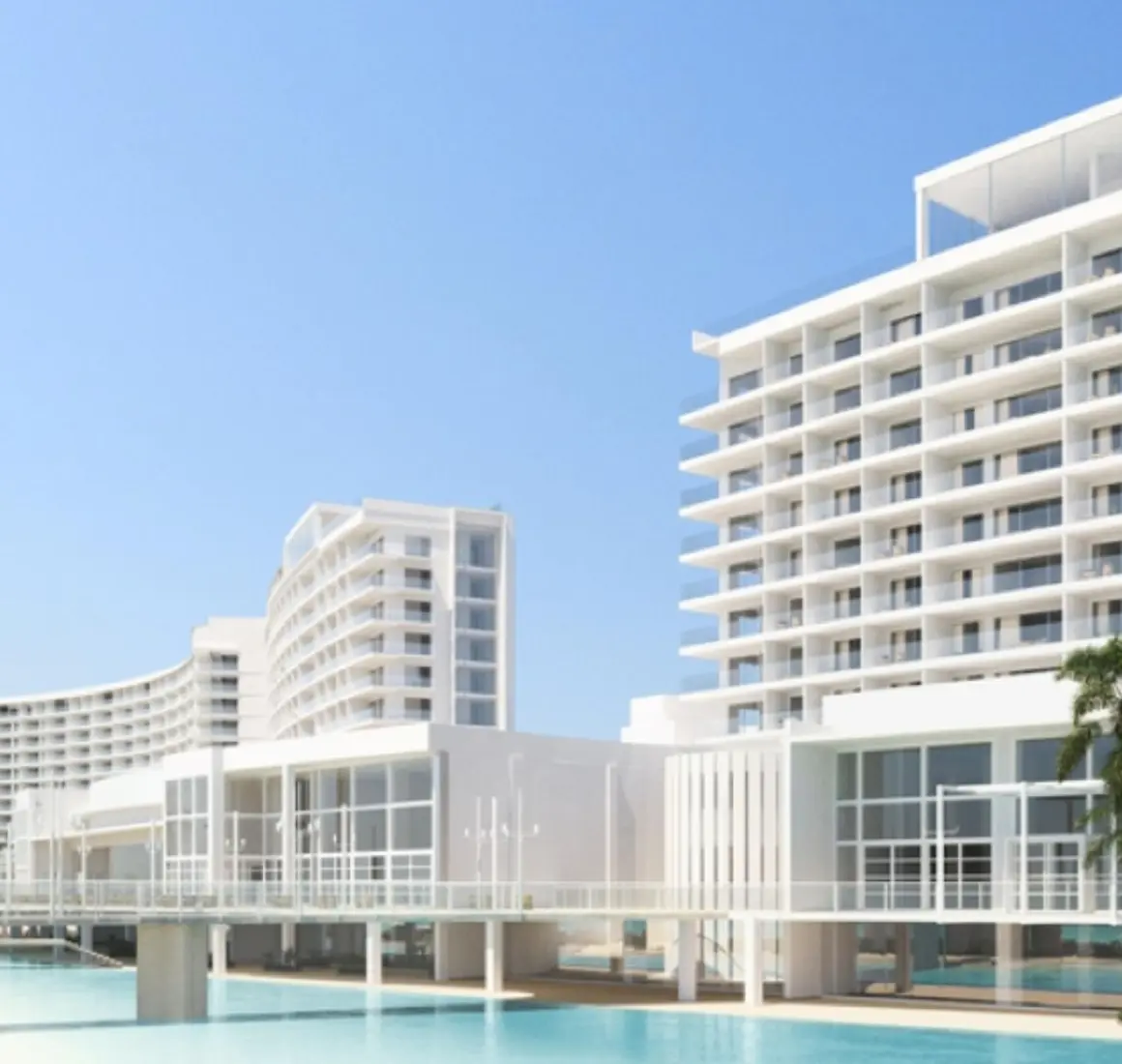 An architectural shot of the modern, white AVA Cancun resort buildings with a pool and palm trees.