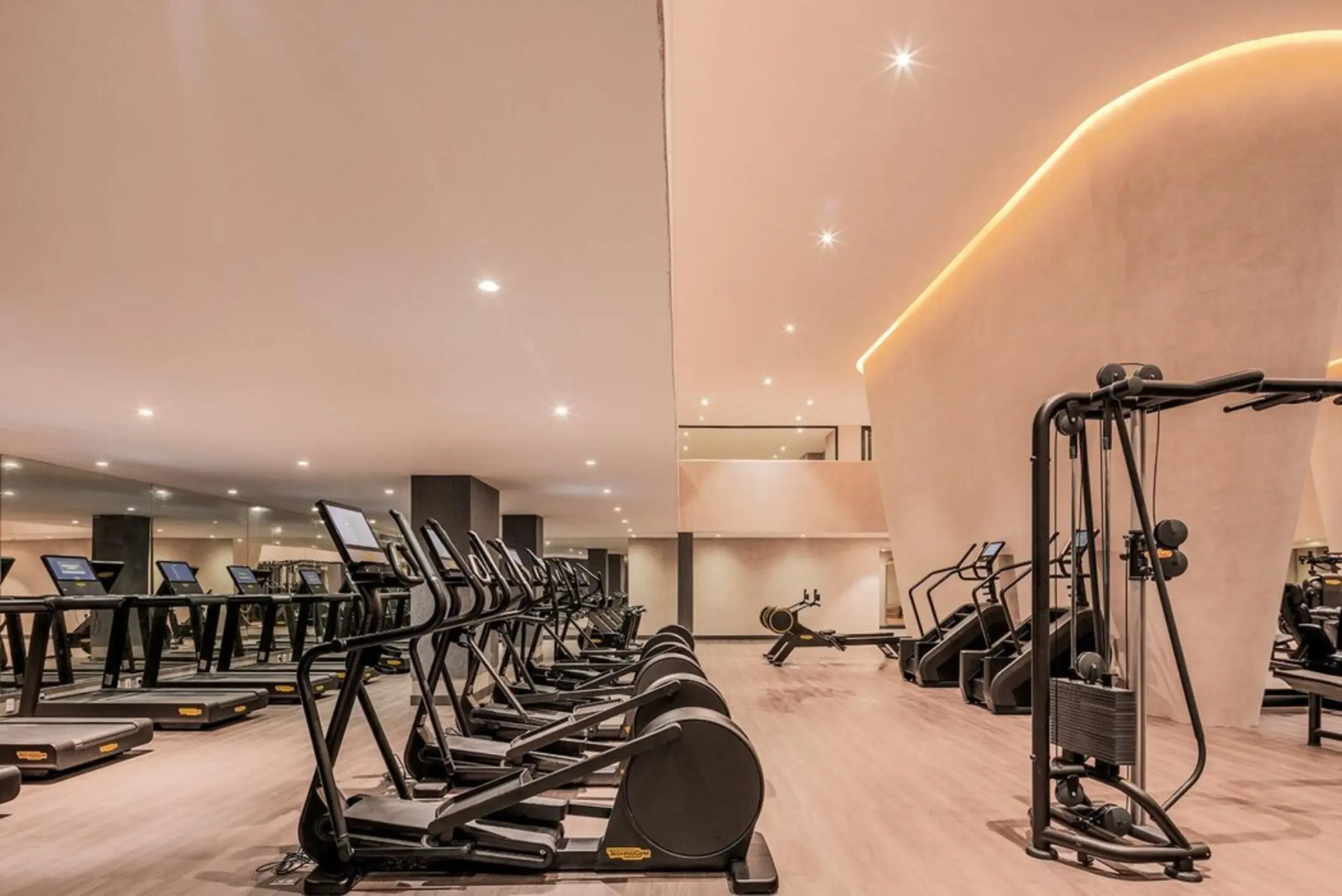 A spacious and well-equipped gym at AVA Cancun with a variety of cardio and weight machines.