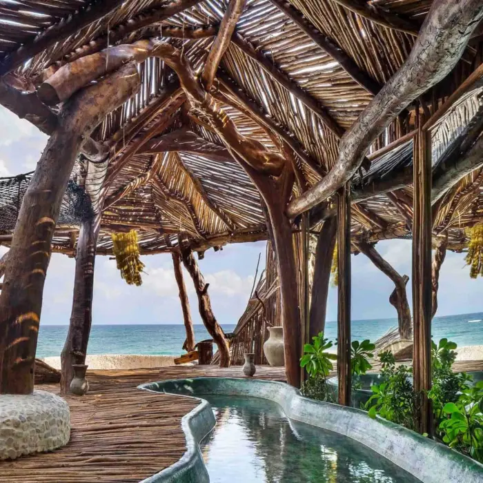 Azulik Tulum pool and rustic wooden elements