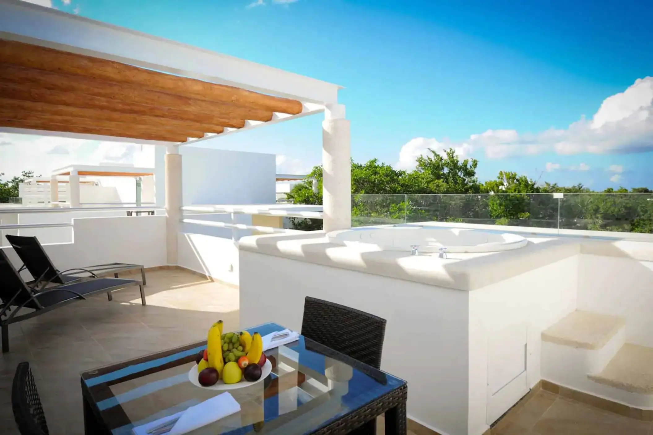 terrace of a suite with hot tub and loungers at Bahia Principe Luxury Sian Ka'an