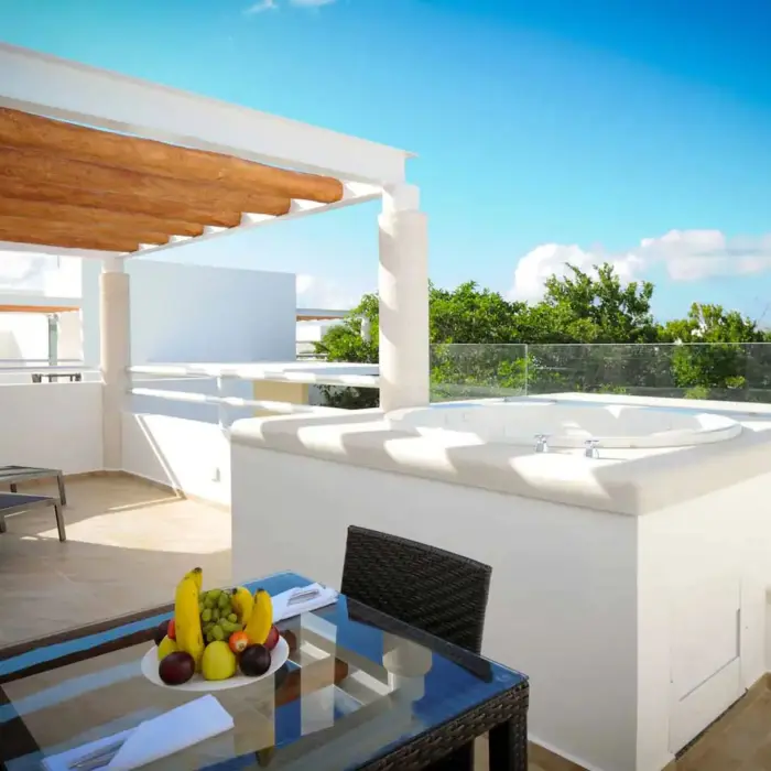 terrace of a suite with hot tub and loungers at Bahia Principe Luxury Sian Ka'an