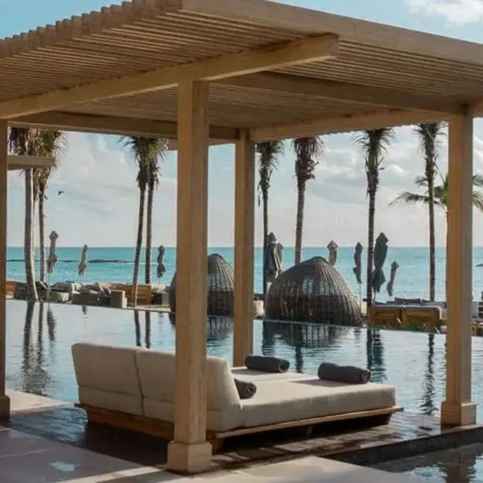 poolside cabana with bed overlooking the sea at Banyan Tree Mayakoba