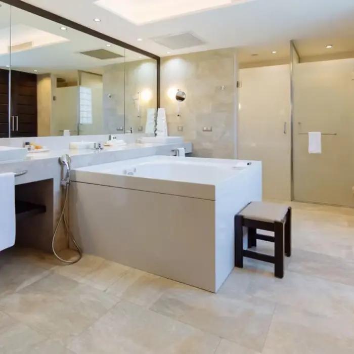 A luxurious and spacious bathroom with a large bathtub, double vanity, and separate shower.