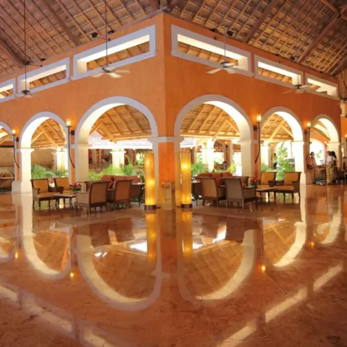 The spacious and elegant lobby of the resort with high ceilings, marble floors, and comfortable seating.