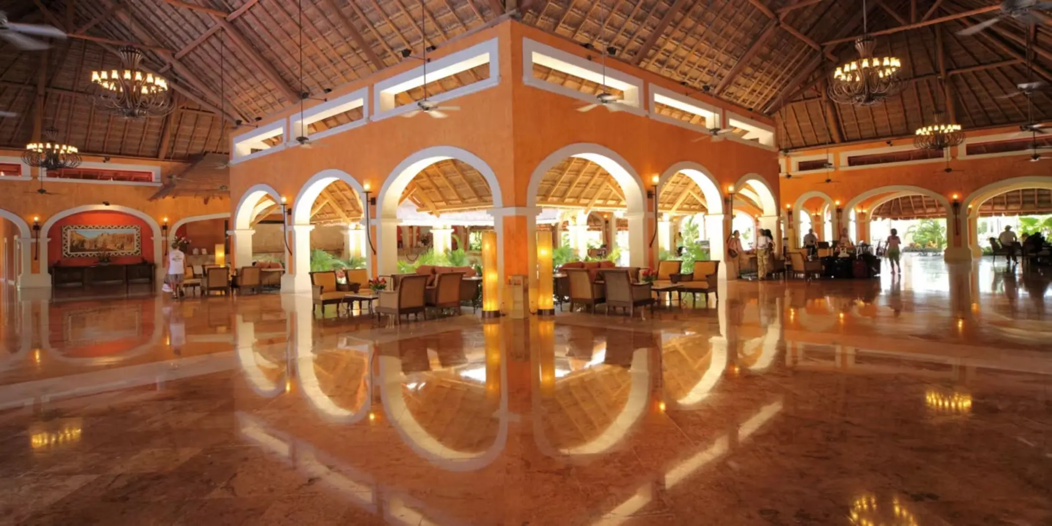 The spacious and elegant lobby of the resort with high ceilings, marble floors, and comfortable seating.