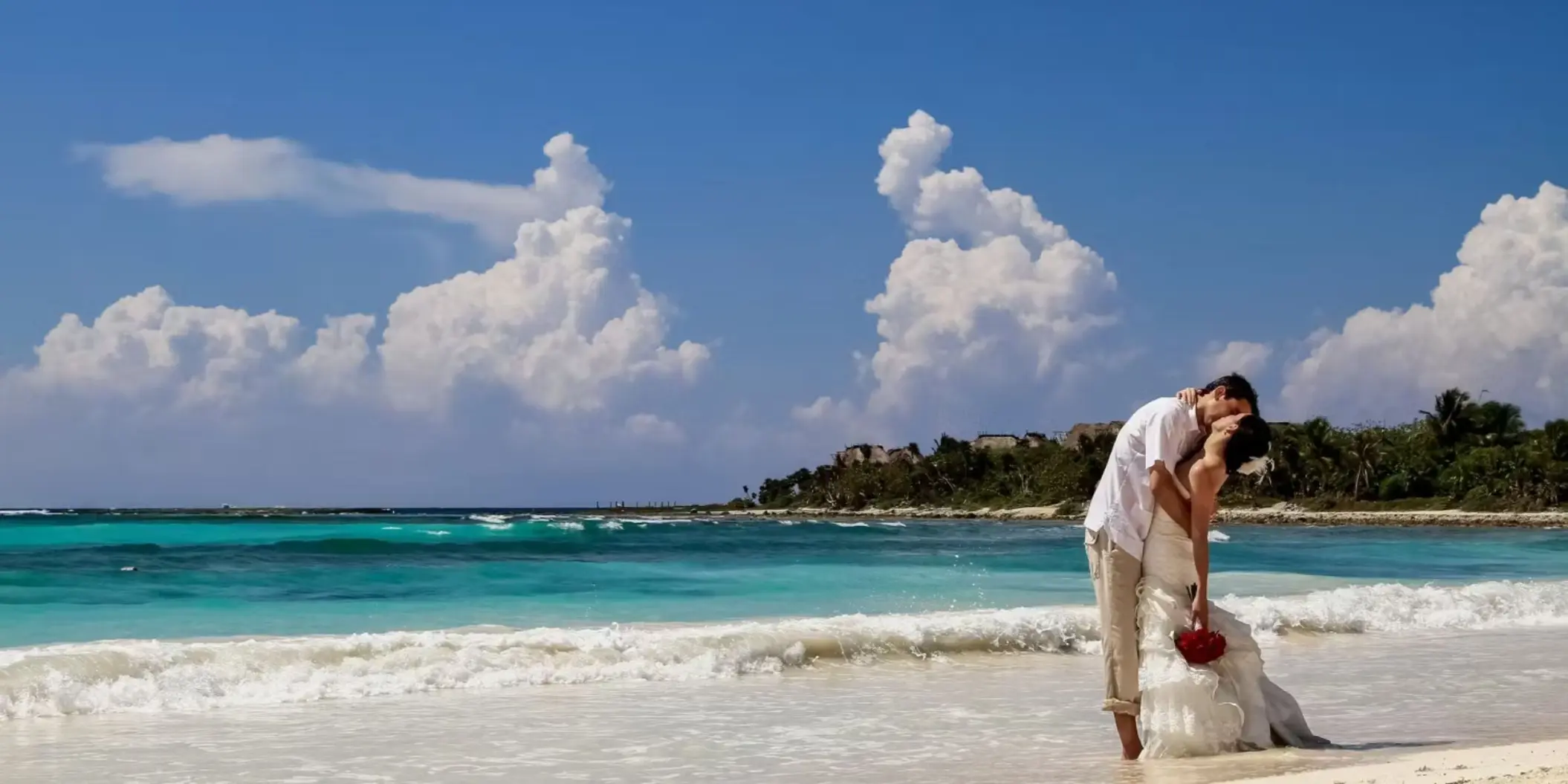 bride and groom on the beach at Barcelo Maya Palace