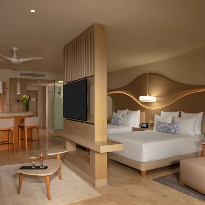 Contemporary junior suite with lagoon views, modern furnishings, and private furnished terrace.