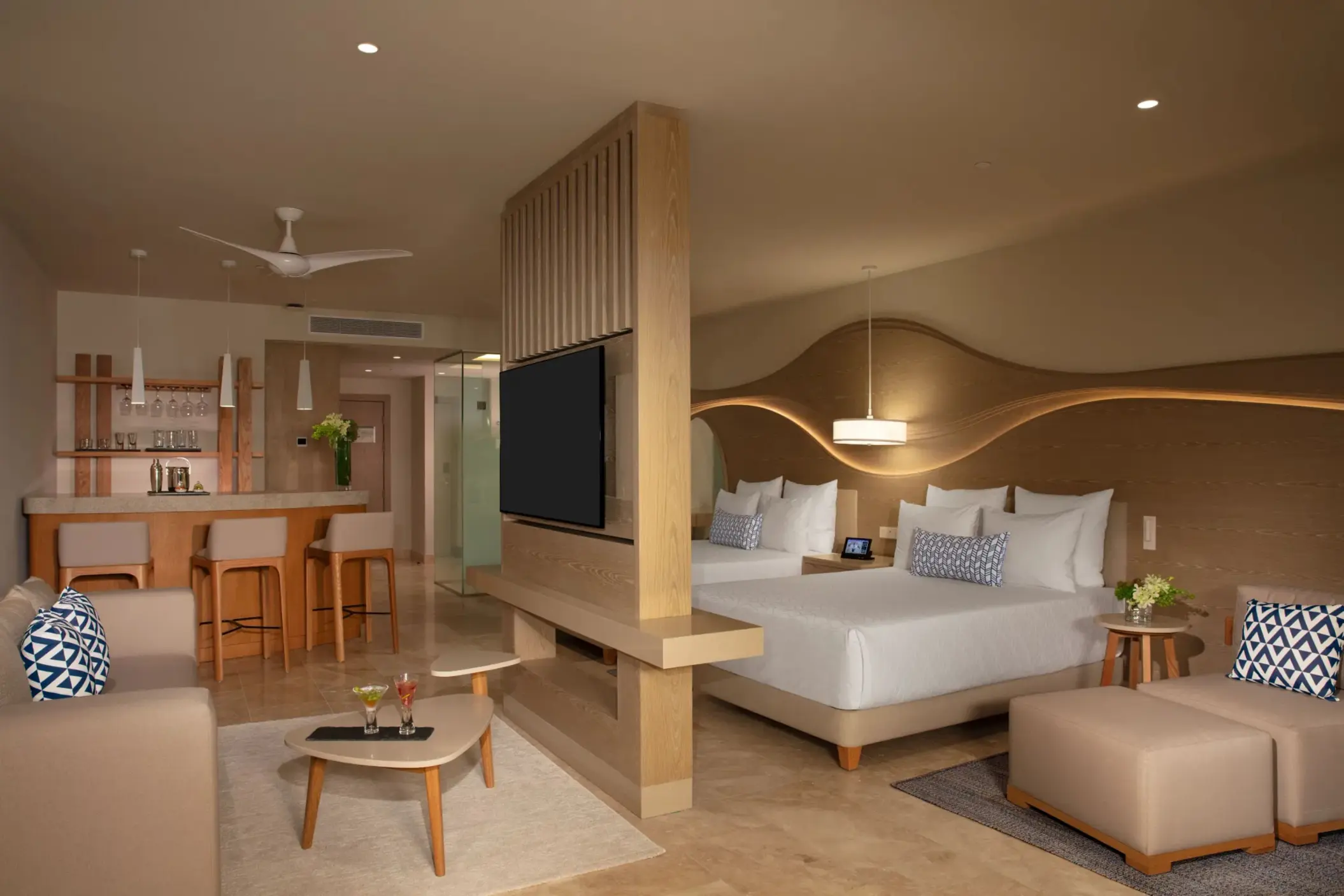 Contemporary junior suite with lagoon views, modern furnishings, and private furnished terrace.