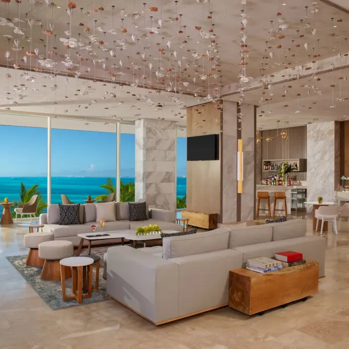 Stylish Xhale Club Lounge with panoramic sea views, bar service, and contemporary furniture.