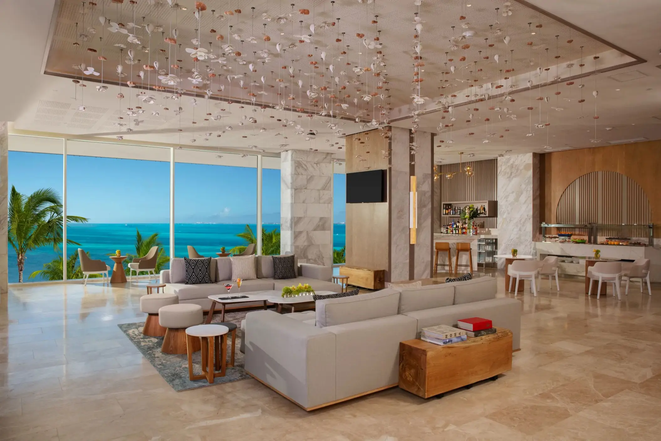 Stylish Xhale Club Lounge with panoramic sea views, bar service, and contemporary furniture.