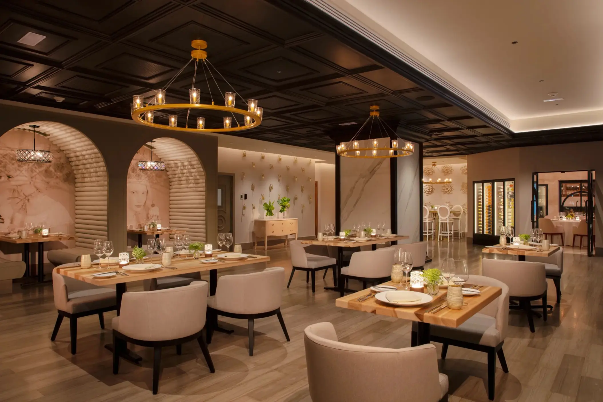 Chic French-inspired Coquette restaurant interior with warm lighting and stylish seating arrangement.