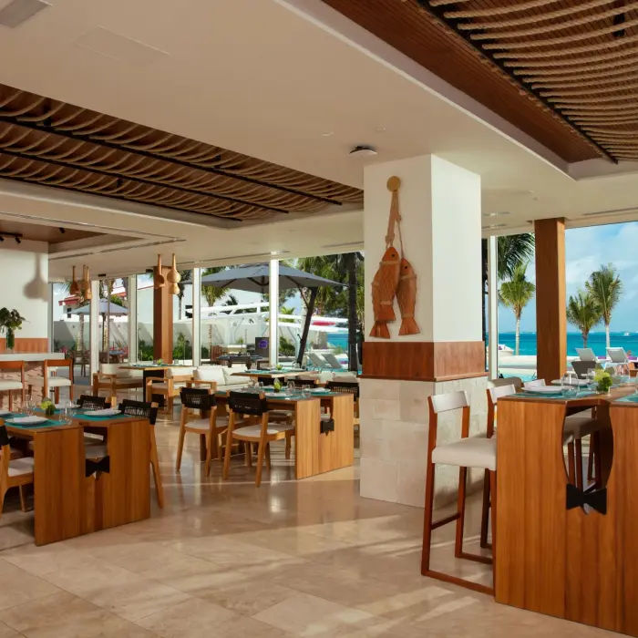 Bright and beachy interior of Fish Nets restaurant with ocean views and nautical-inspired design.