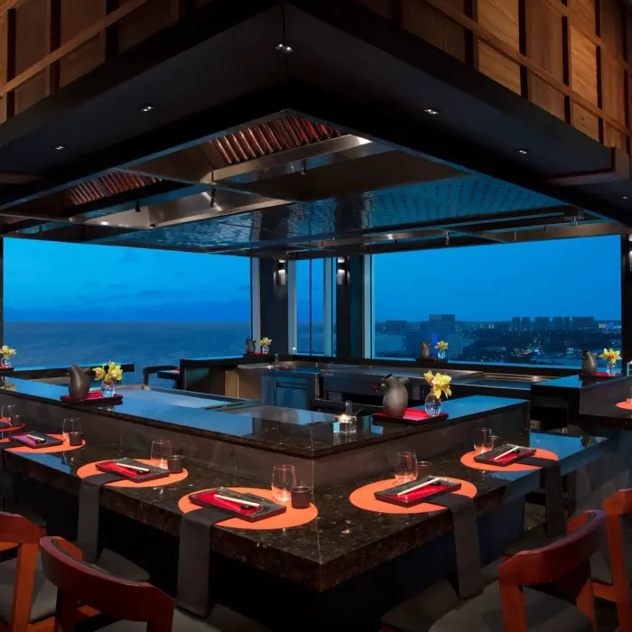 Teppanyaki station at Silk City restaurant with ocean views and interactive dining layout.