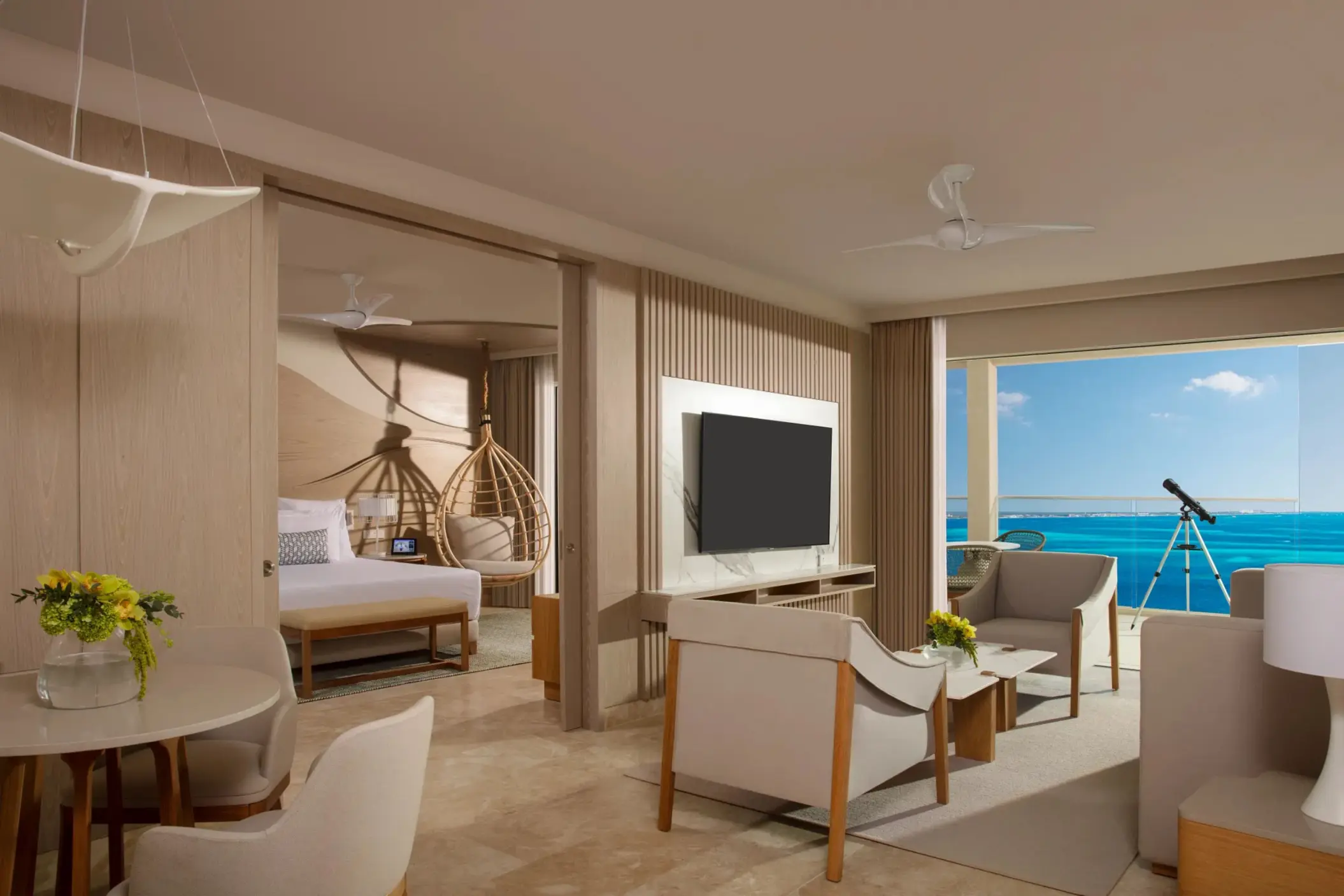 Master suite living room with oceanview terrace, telescope, modern decor, and separate bedroom entrance.