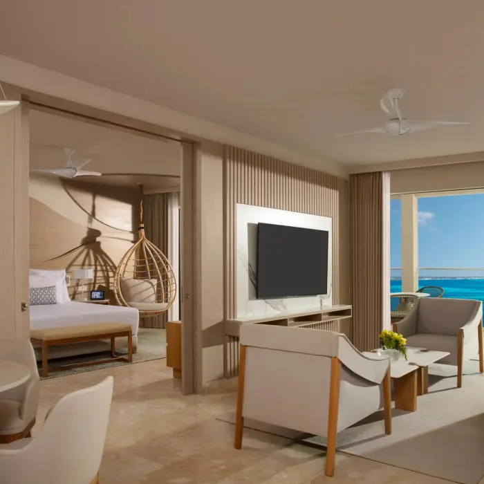 Master suite living room with oceanview terrace, telescope, modern decor, and separate bedroom entrance.