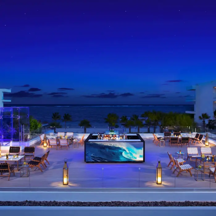 Rooftop cocktail setup on Purple Terrace with LED-lit bar and ocean backdrop.