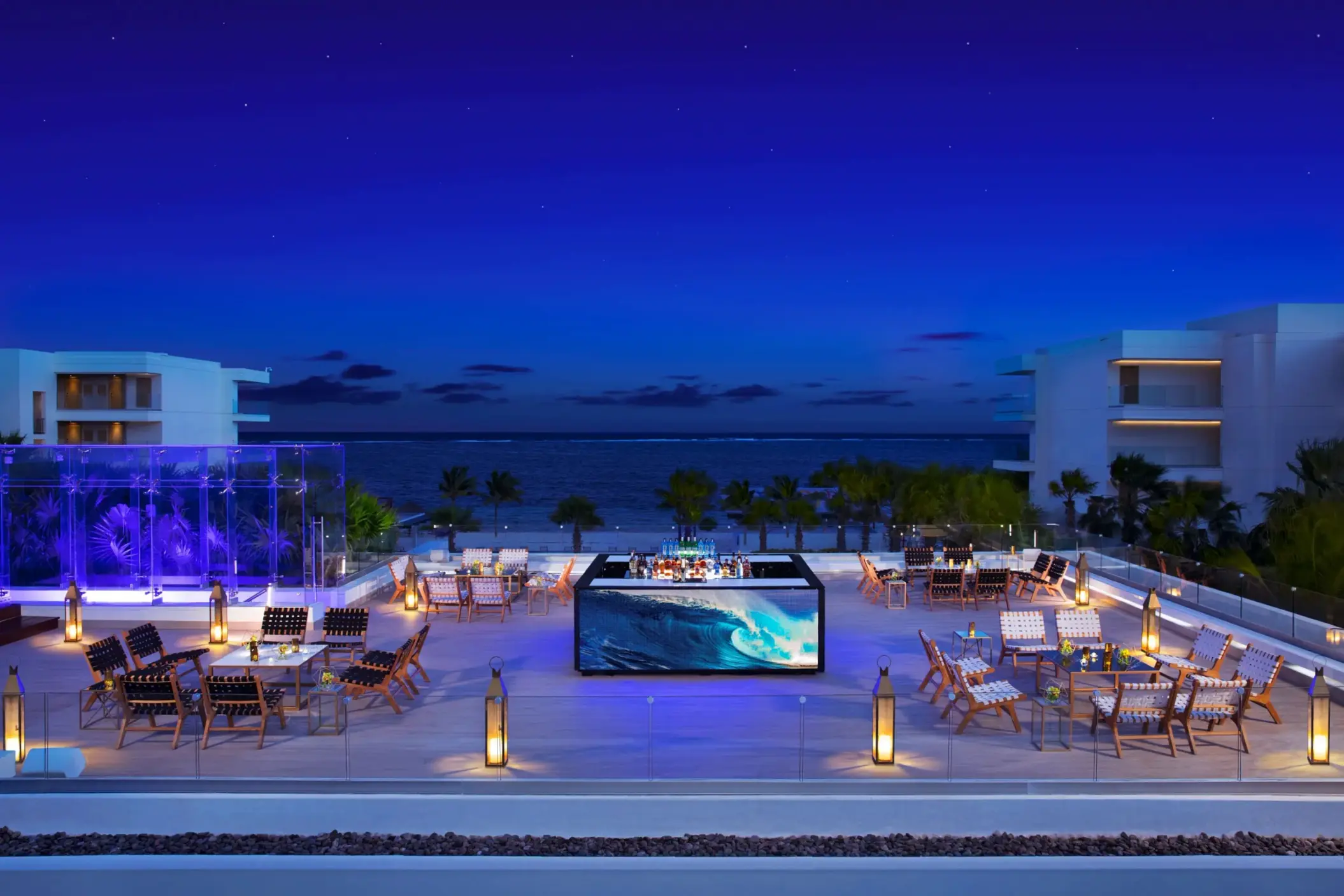 Rooftop cocktail setup on Purple Terrace with LED-lit bar and ocean backdrop.