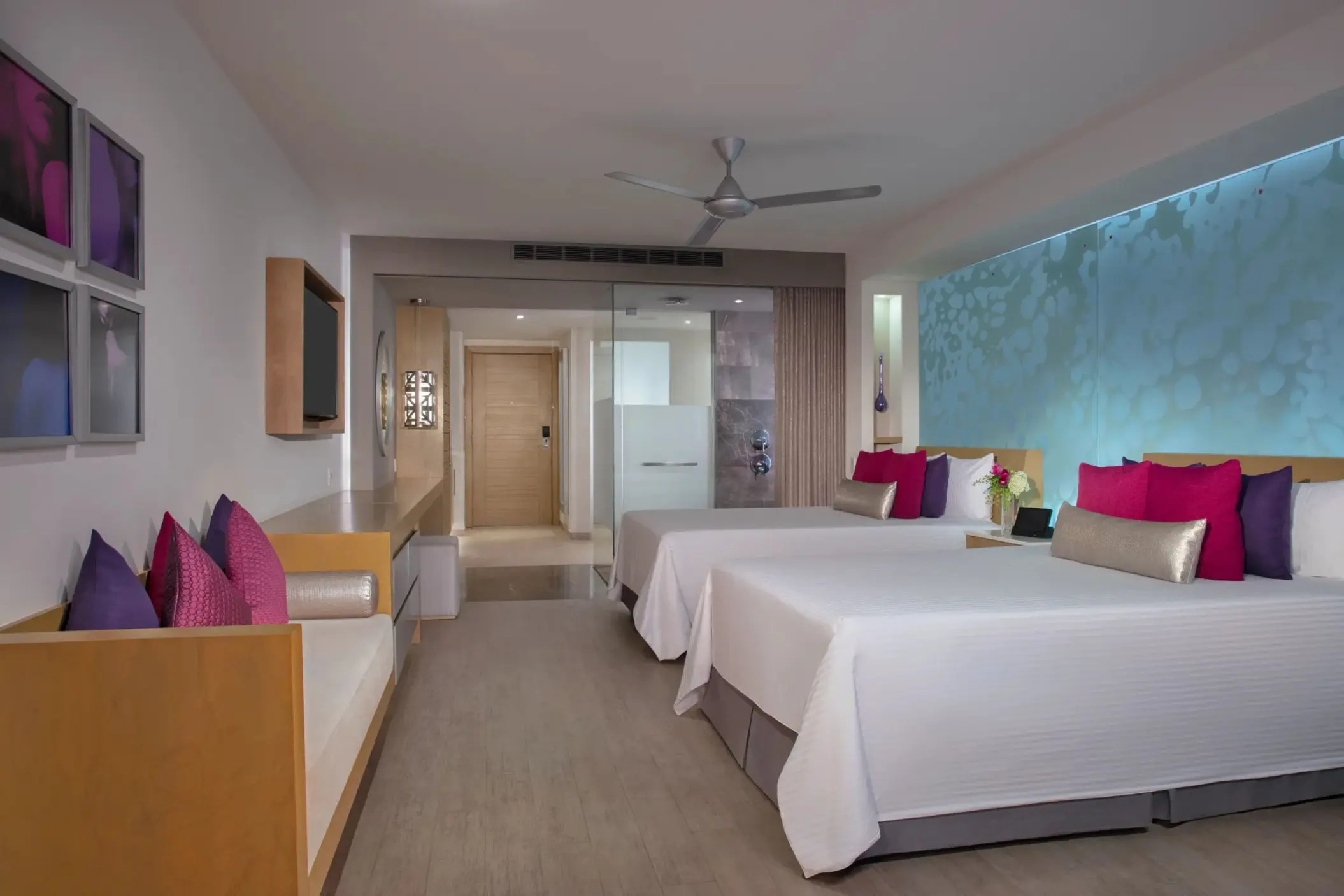 Spacious junior suite with two beds, soft lighting, and a relaxing modern vibe.