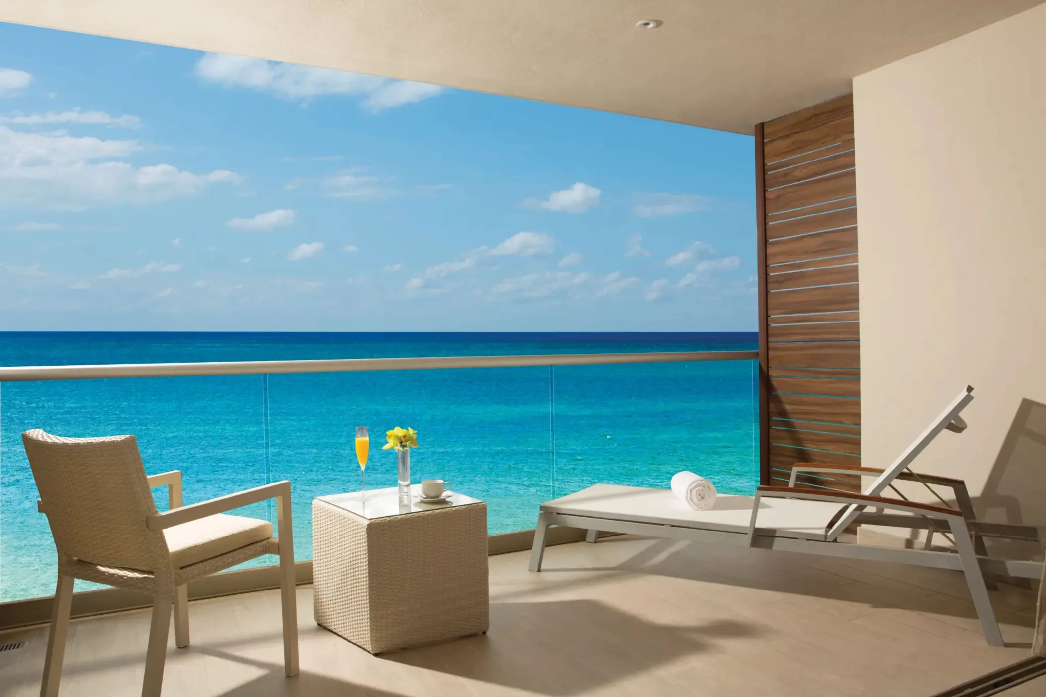 Private terrace with sun loungers and sweeping turquoise ocean views.