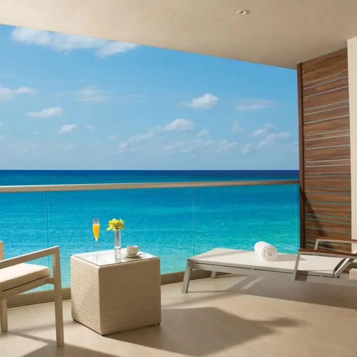 Private terrace with sun loungers and sweeping turquoise ocean views.