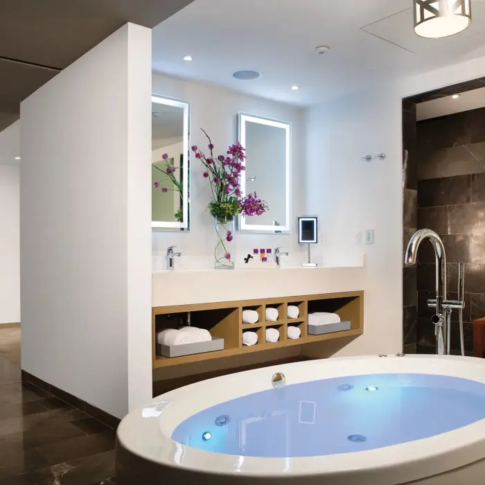 Master bathroom with deep soaking tub, dual vanities, and luxury finishes.