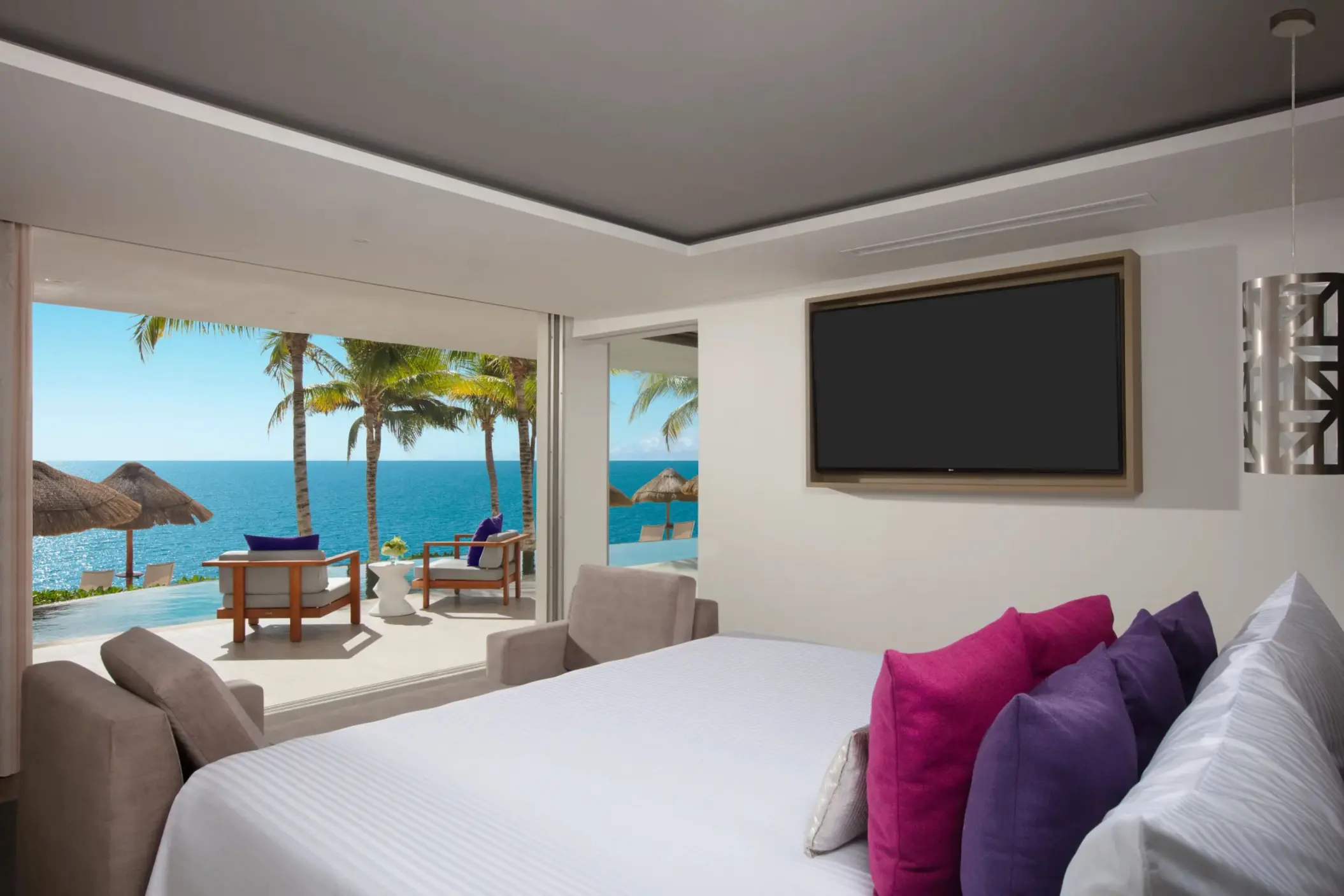 Presidential suite with ocean views, plush pillows, and direct terrace access at Breathless Riviera Cancun Resort.