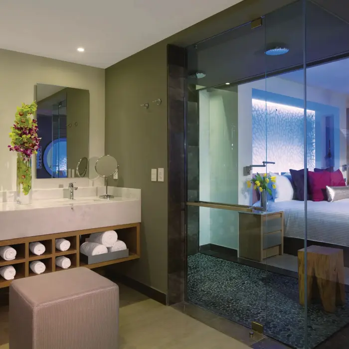Modern bathroom with dual vanities, rainfall shower, and spa-style design.