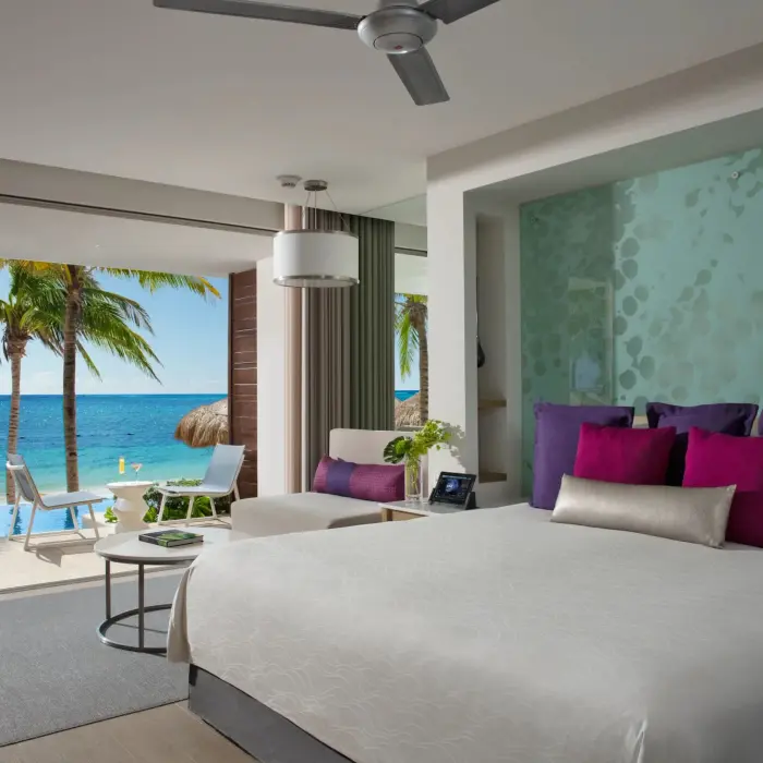 Swim-out junior suite with oceanfront terrace and direct pool access.