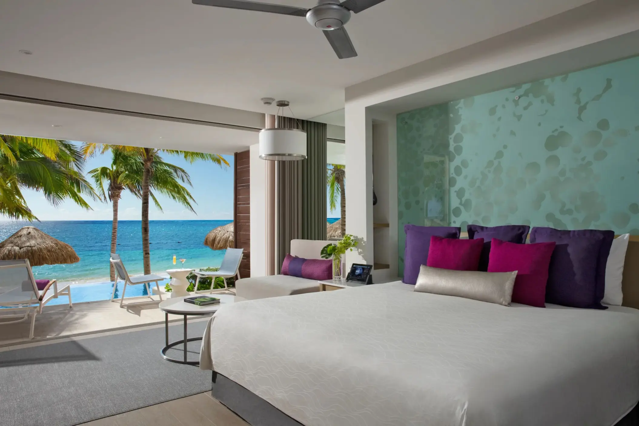Swim-out junior suite with oceanfront terrace and direct pool access.