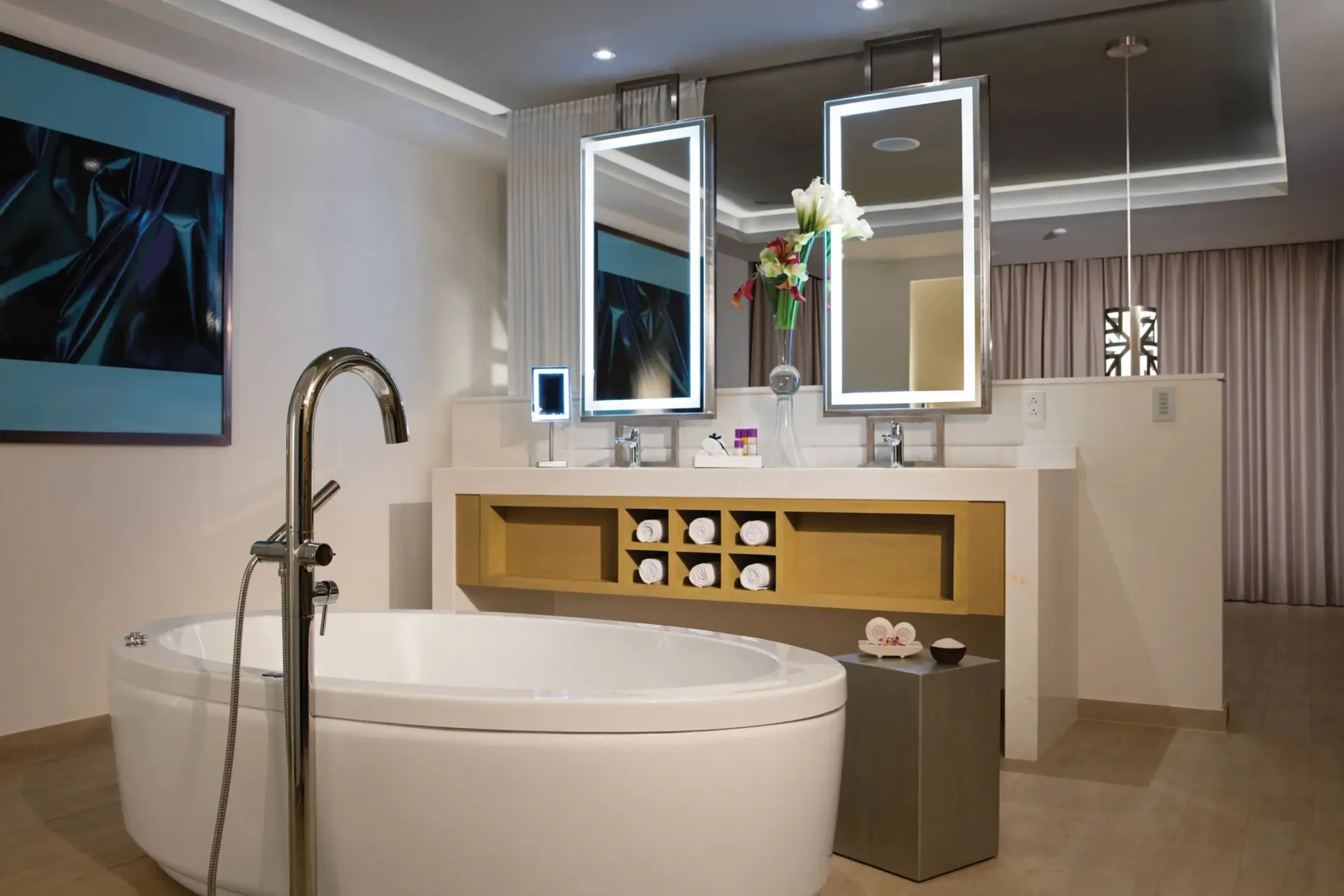 Double vanity bathroom with round soaking tub, lighted mirrors, and plush resort amenities.