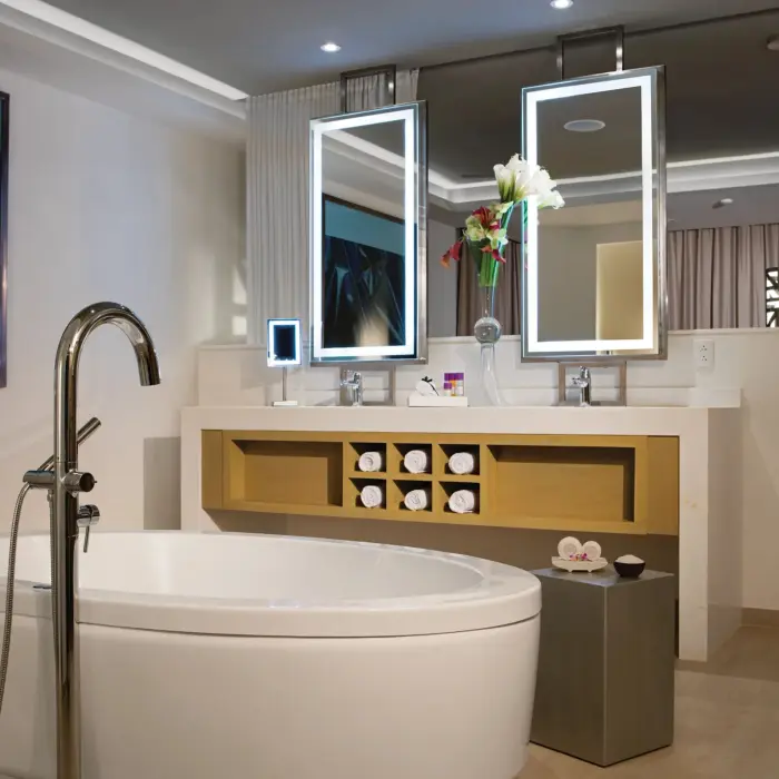 Double vanity bathroom with round soaking tub, lighted mirrors, and plush resort amenities.