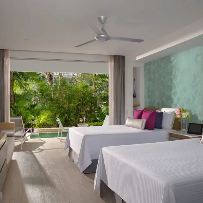Xhale Club junior suite with two beds, tropical view, and semi-private pool steps from the terrace.
