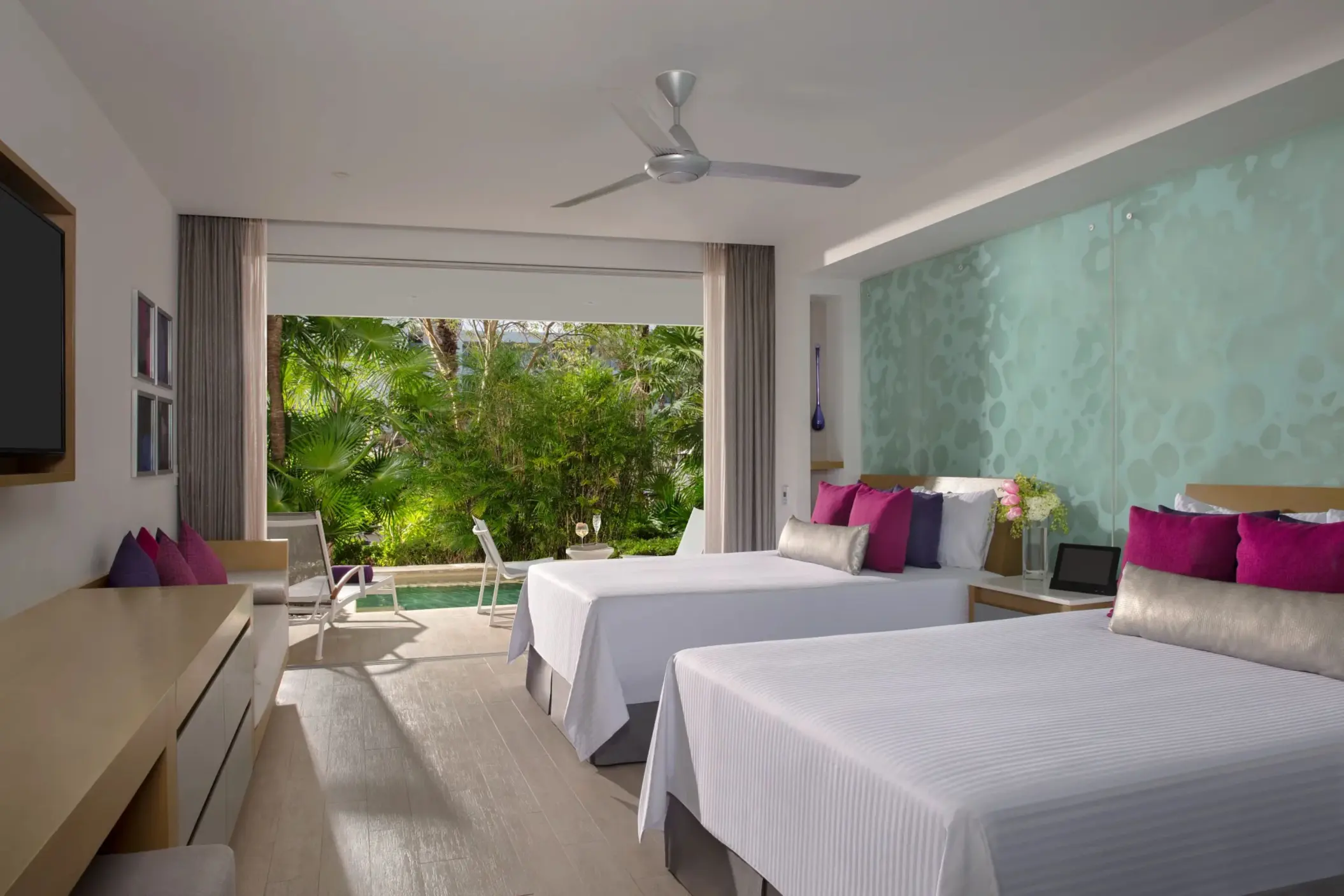 Xhale Club junior suite with two beds, tropical view, and semi-private pool steps from the terrace.