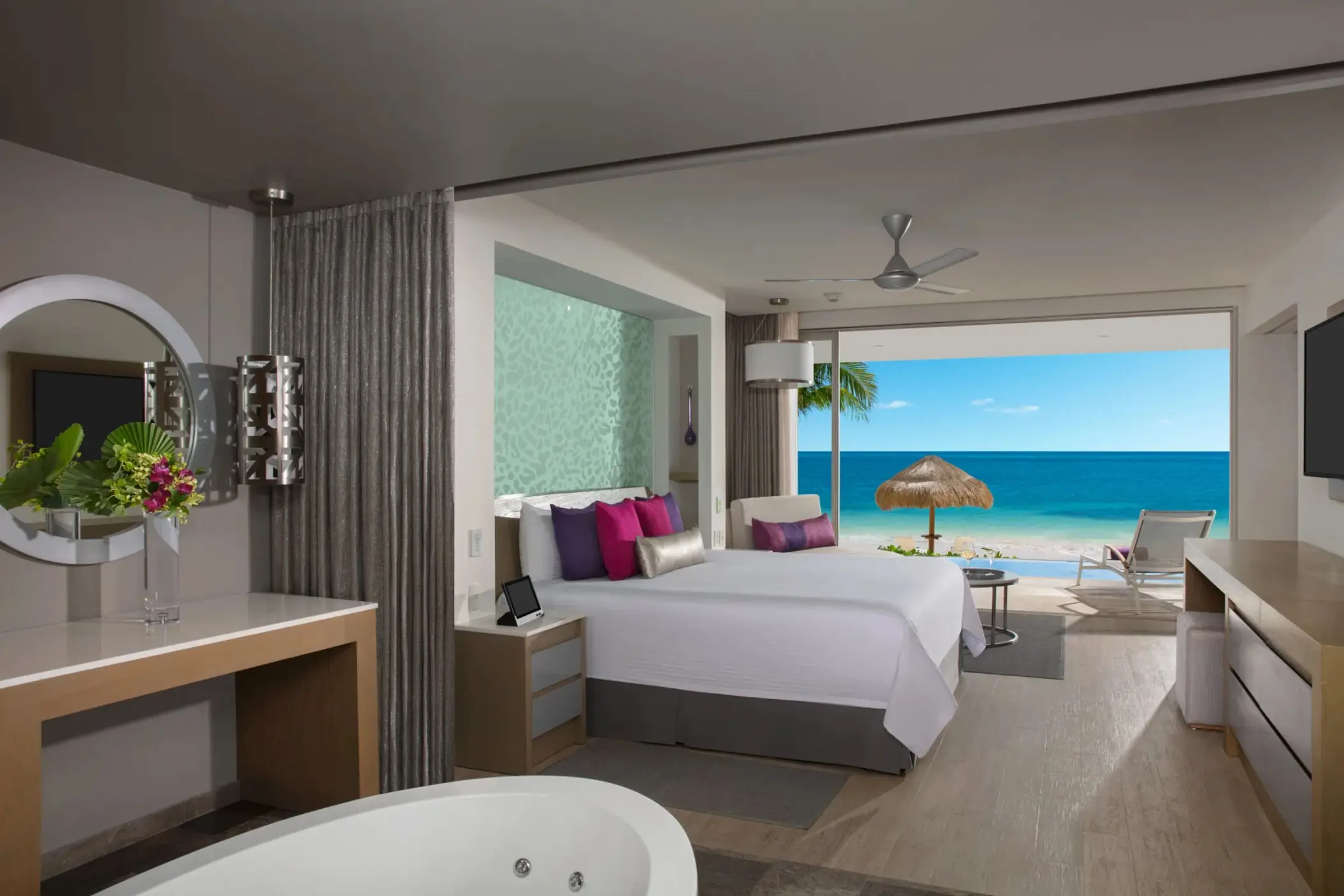 Oceanfront master suite with a king bed, soaking tub, and private terrace overlooking the Caribbean Sea.