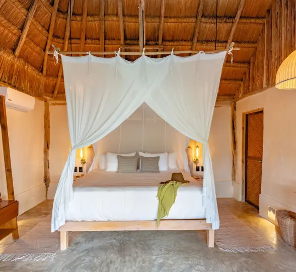 suite with poster bed at Casa Ganesh tulum