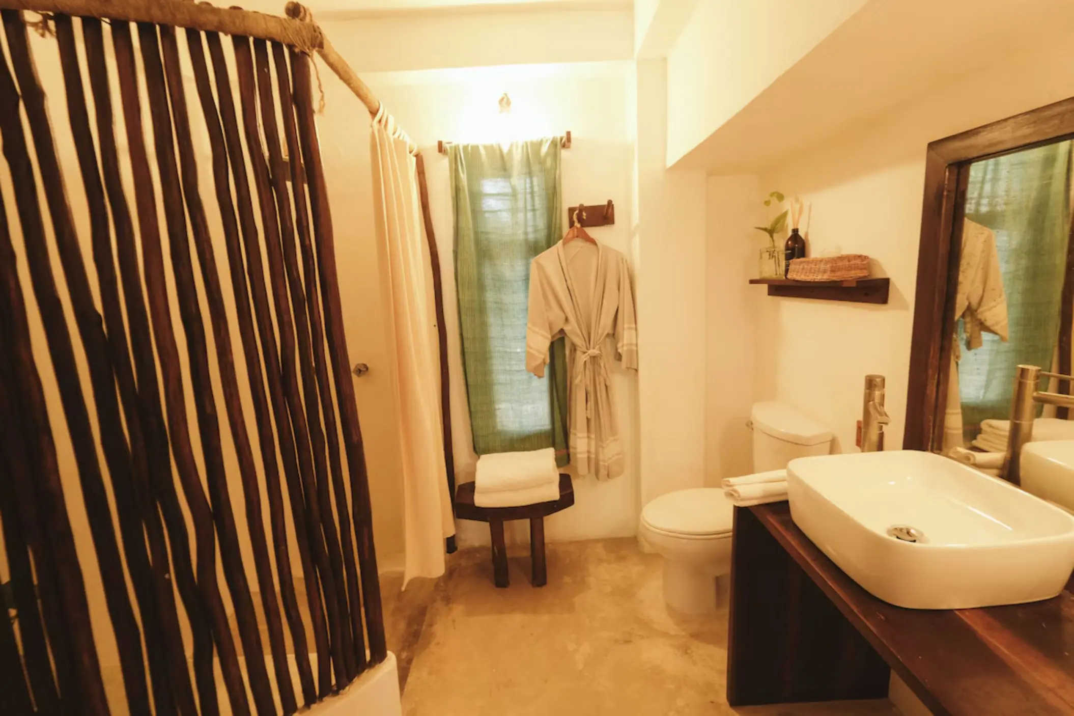 washroom of romantic room with bathrobe hanging on the wall at Casa Violeta