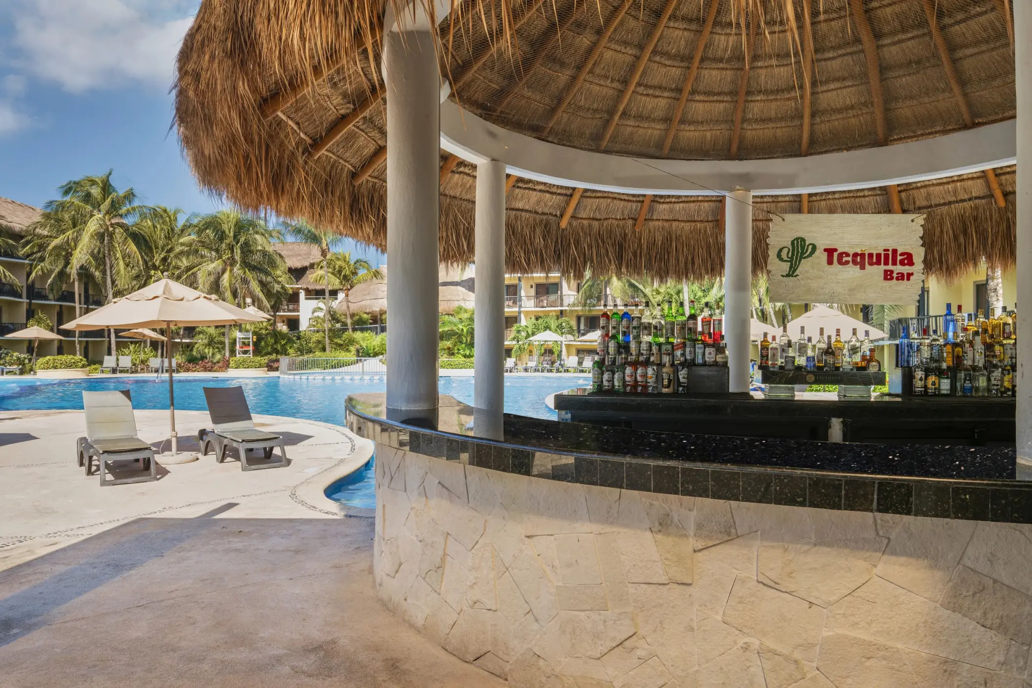A thatched-roof swim-up bar with 