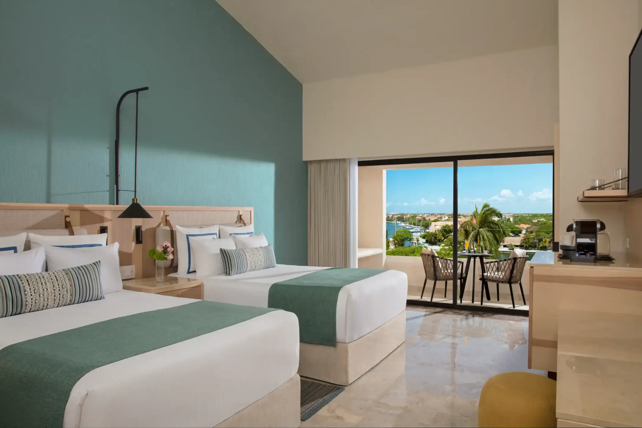 Deluxe double room with serene marina views, two plush beds, and tropical-inspired design.