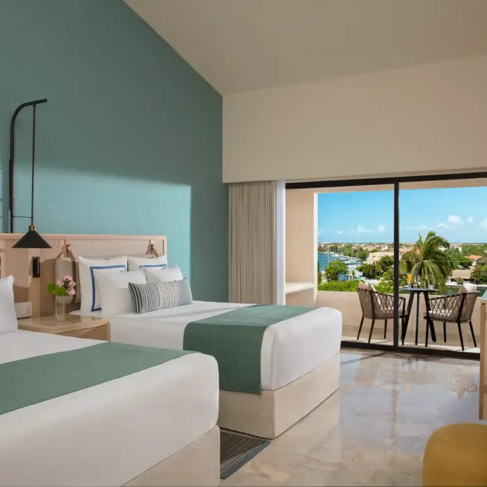 Deluxe double room with serene marina views, two plush beds, and tropical-inspired design.